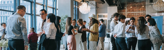 A group of people standing around in a modern office setting